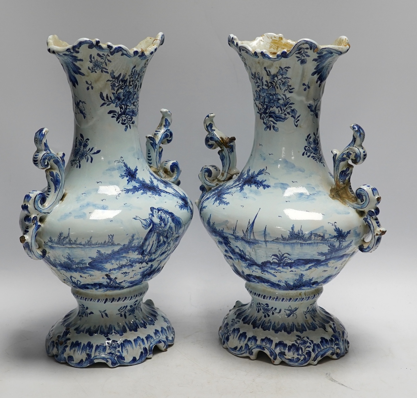 A pair of 19th century Delft blue and white vases, 35cm high. Condition - poor